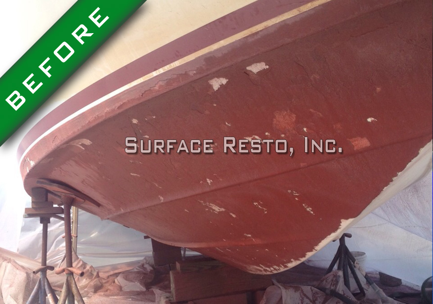 Peeling red bottom paint on a Rhode Island boat hull before removal