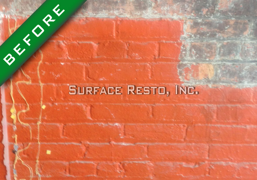 Painted brick wall before sandblasting paint removal