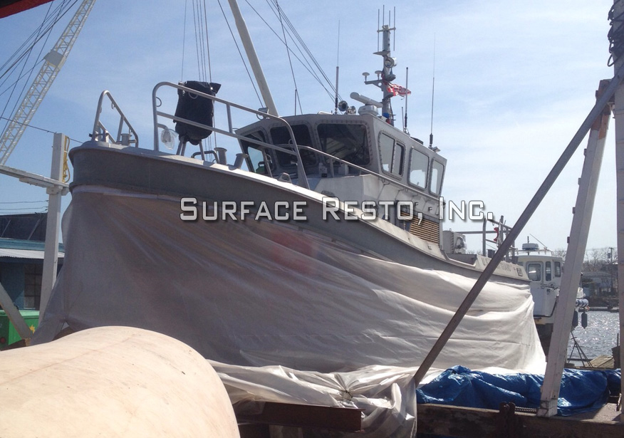 Massachusetts work boat wrapped for bottom paint removal