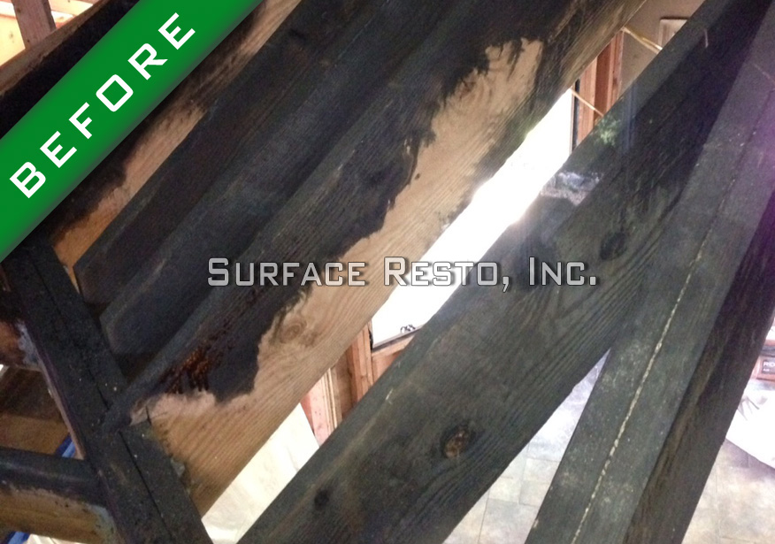 Fire-charred wooden stair stringers before restoration