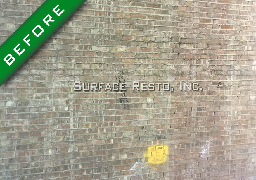 Painted brick wall before sandblasting paint removal