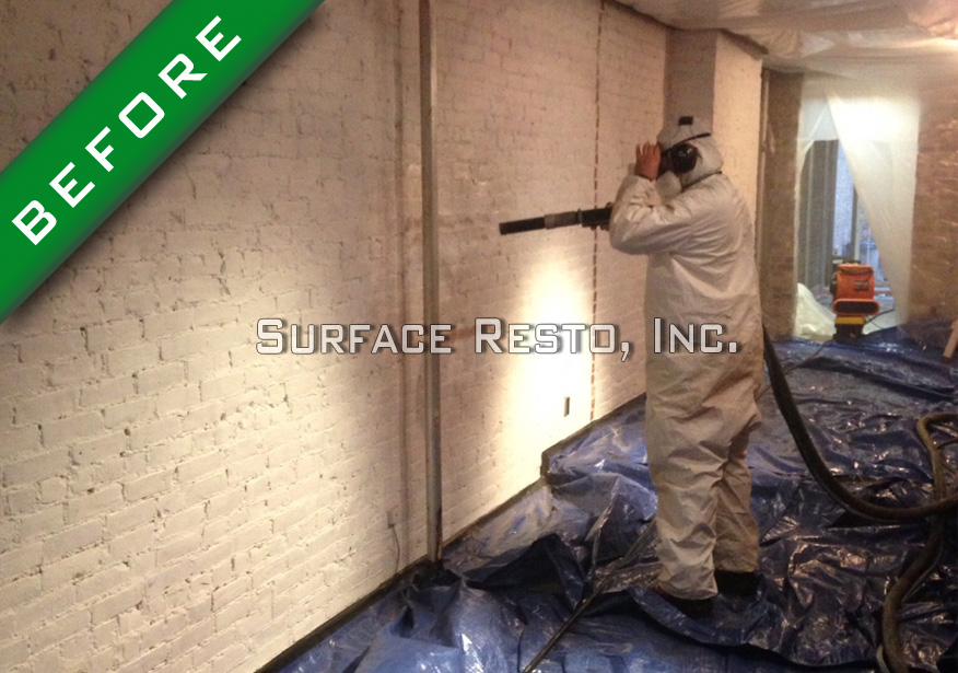 Painted brick wall before sandblasting paint removal