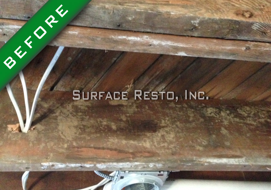 Smoke-stained basement floor joists before fire restoration