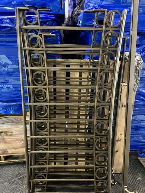 Stack of decorative iron fence panels after powder coating
