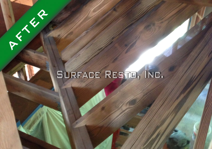 Wooden stair stringers after fire damage and soot removal