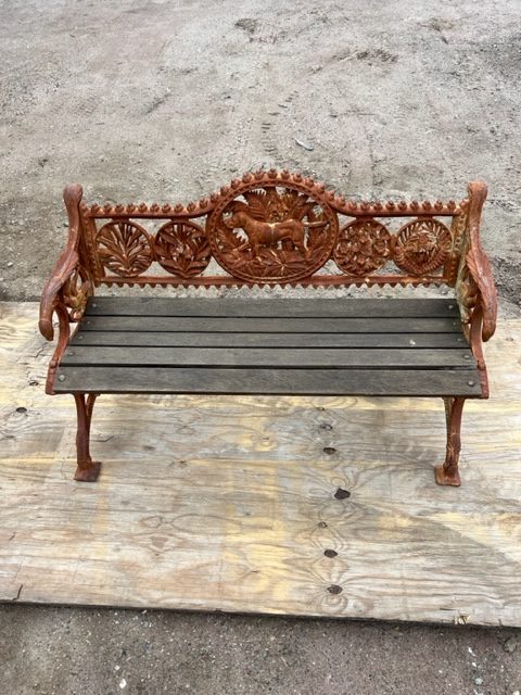 Rusted cast-iron park bench before sandblasting and powder coating
