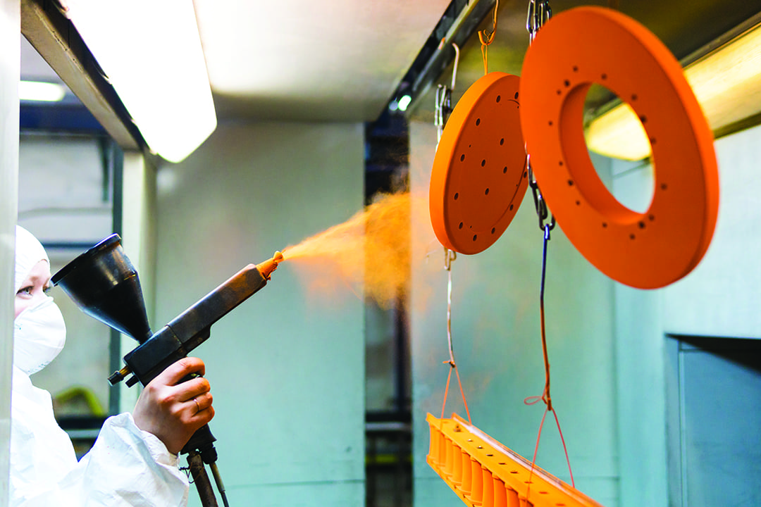 Orange powder coating sprayed onto metal discs