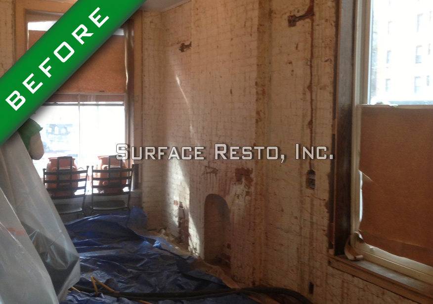 Painted brick wall before sandblasting paint removal